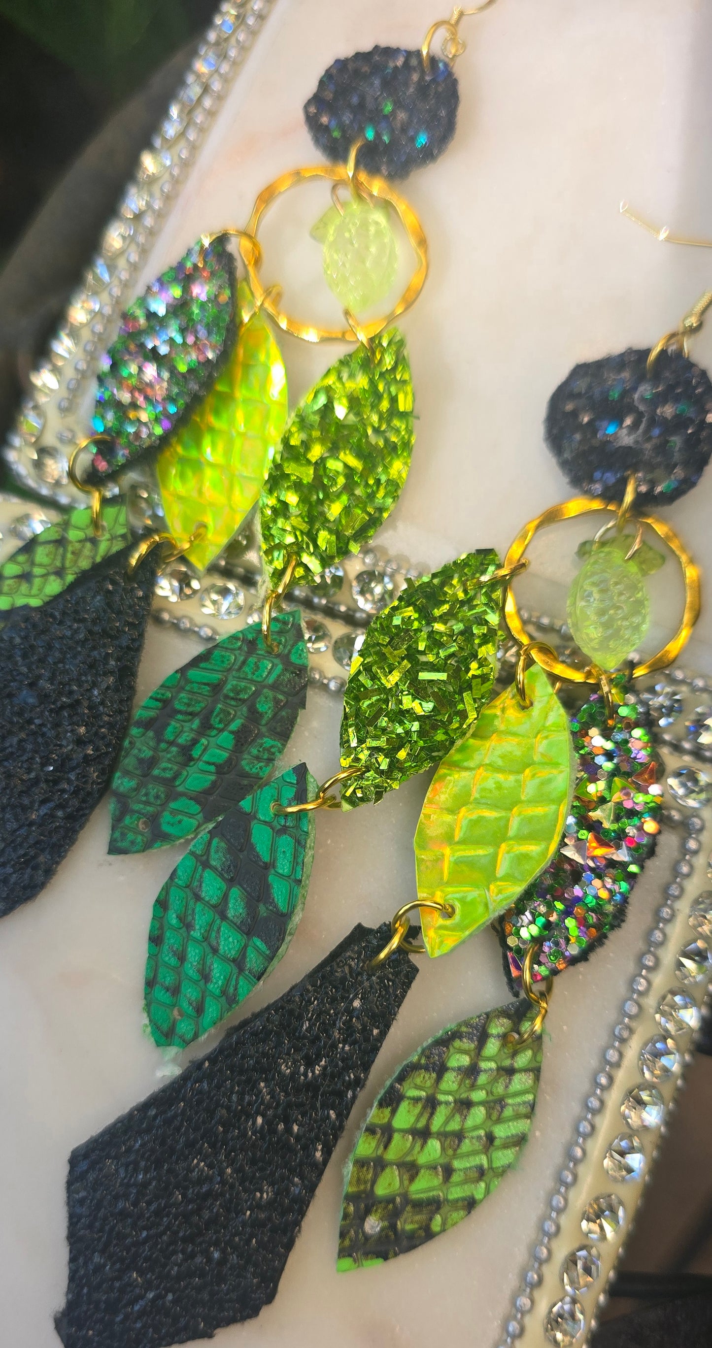 Green geometric dangle earrings from the Shannon collection by Shop Moxxc, featuring modern chandelier-style design.
