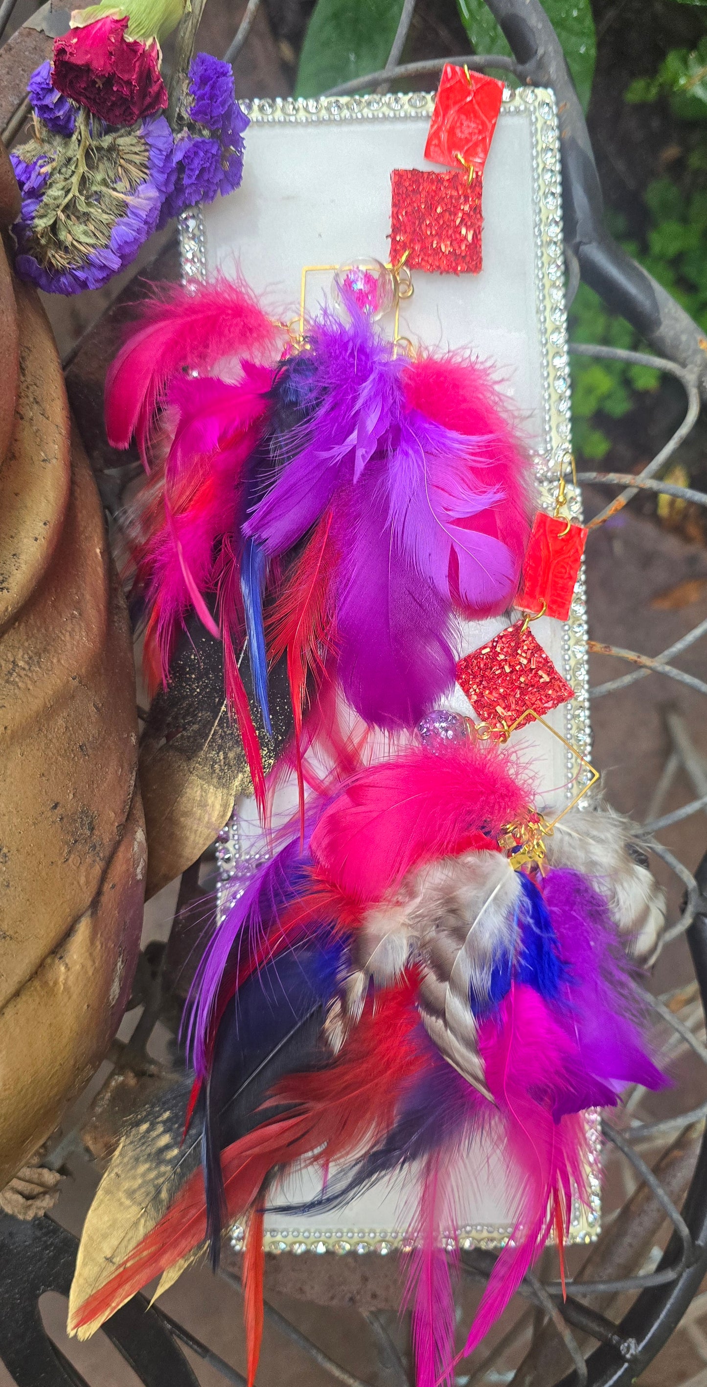 Pink boho festival feather earrings from Shop Moxxc, featuring colorful feathers and intricate design details.