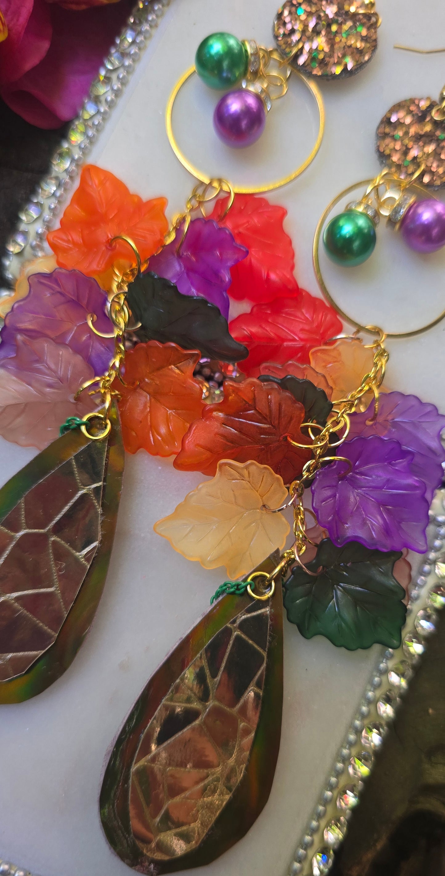 Multicolored gold layered statement earrings by Shop Moxxc, featuring vibrant, intricate design for bold fashion accents.