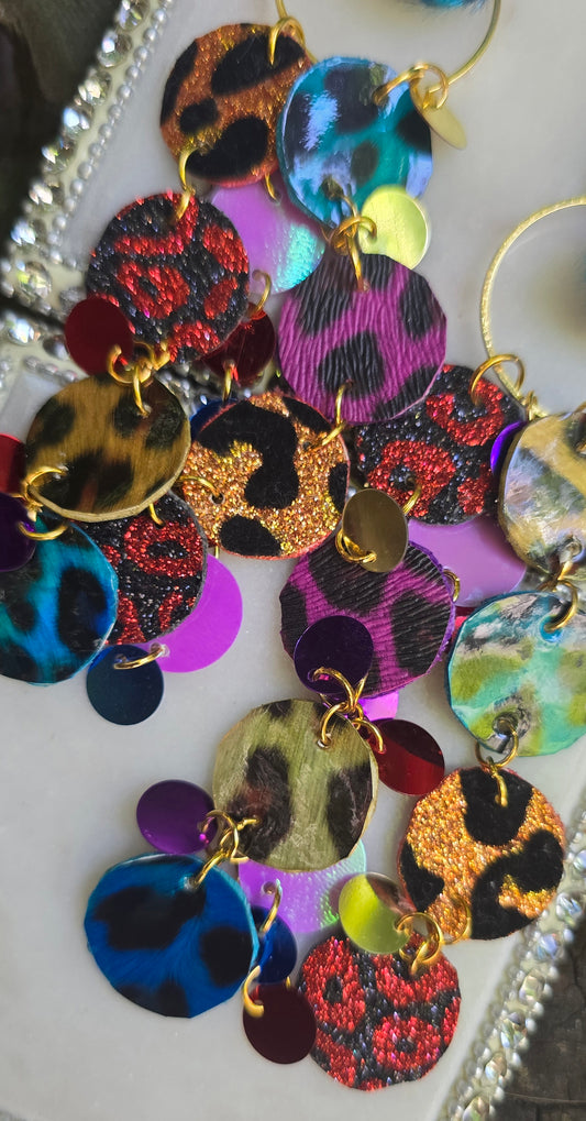 Multicolored animal print funky dangle earrings featuring bold, playful design from Shop Moxxc, with colorful patterns and stylish shape.