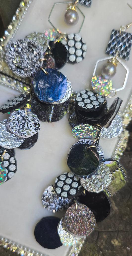 Black polka-dot round earrings from Shop Moxxc featuring a stylish, circular design with a playful polka-dot pattern.
