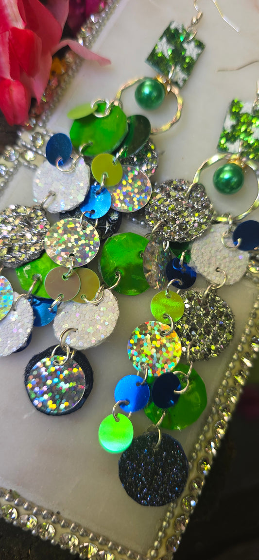 Green round dangle earrings from Shop Moxxc's Natalie collection, featuring sleek circular design and vibrant green color.