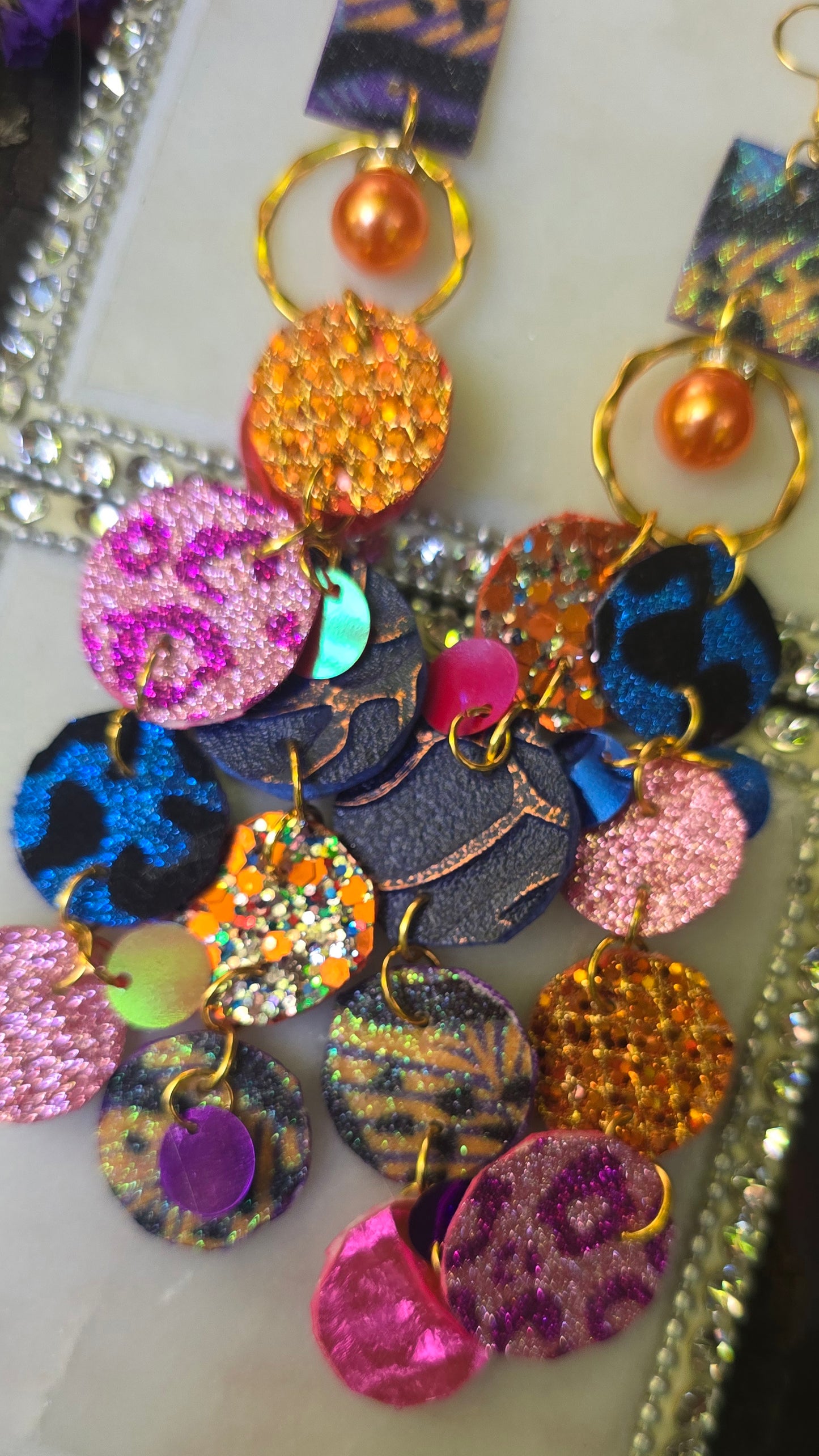 Ivonne orange multicolored round dangle earrings with geometric patterns, crafted by Shop Moxxc.