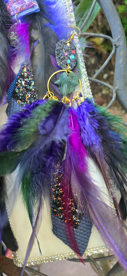 Dark blue feather earrings named Helen, featuring lightweight feather design with silver hooks, from Shop Moxxc.