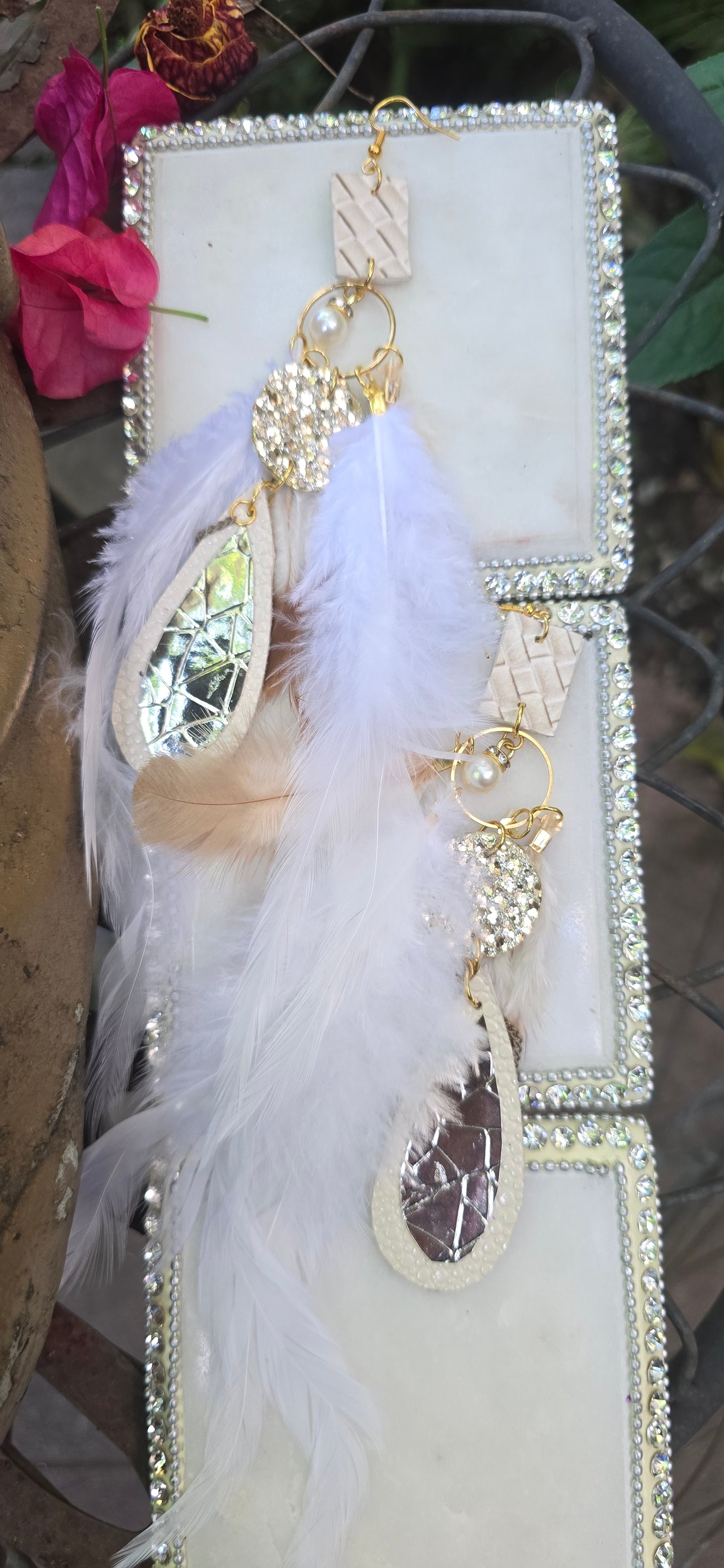 White long feather earrings by Shop Moxxc featuring elegant feather design and lightweight dangle style.