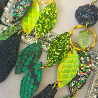 Green geometric dangle earrings from the Shannon collection by Shop Moxxc, featuring modern chandelier-style design.