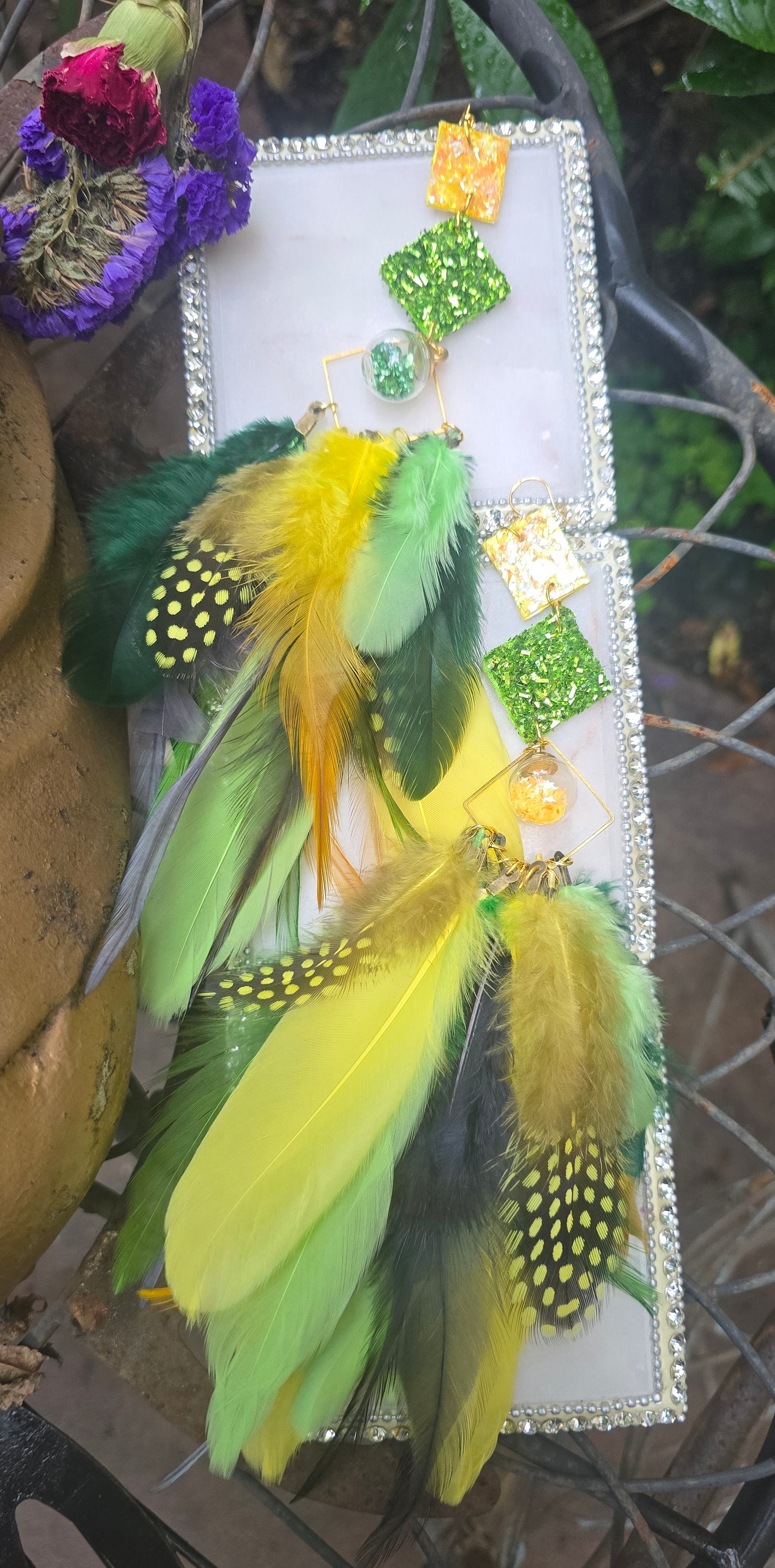 Green boho festival feather earrings by Shop Moxxc, showcasing vibrant feathers and a stylish design.