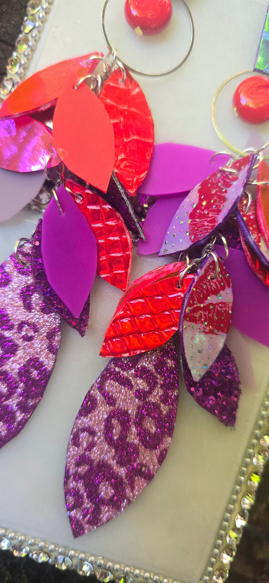 Hot pink multicolored teardrop chandelier earrings by Shop Moxxc featuring vibrant, intricate designs and dangling gemstone accents.