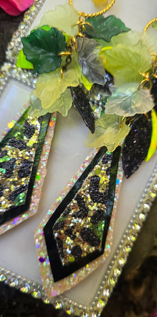 Green teardrop chandelier earrings by Paige featuring intricate design, hanging from gold hooks, perfect for elegant accessories.