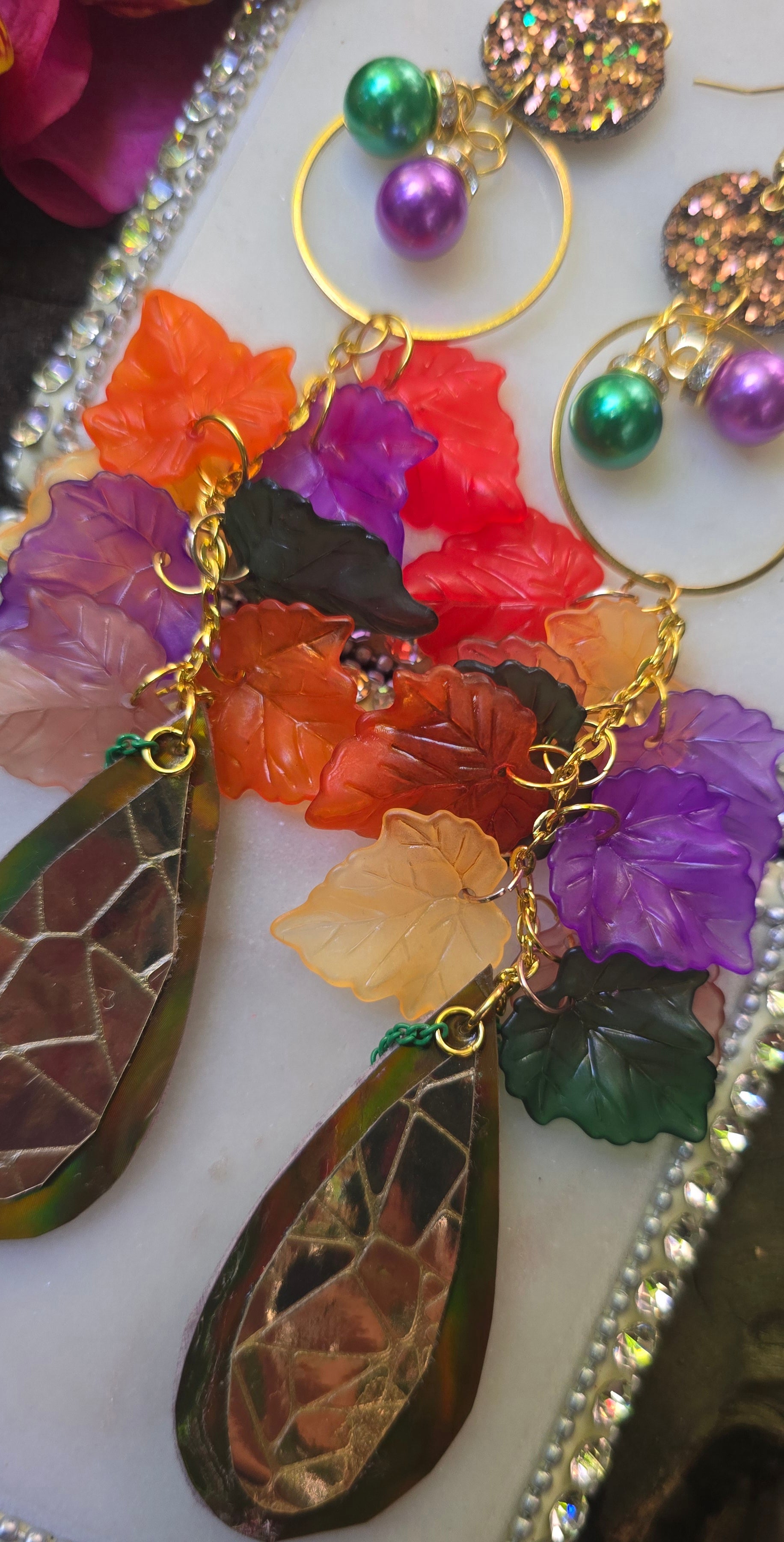 Multicolored gold layered statement earrings by Shop Moxxc, featuring vibrant, intricate design for bold fashion accents.