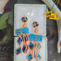 Orange geometric fringe earrings featuring bold fringe and modern design from Shop Moxxc's Holly collection.