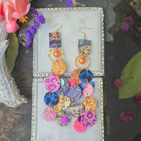 Ivonne orange multicolored round dangle earrings with geometric design, stylish jewelry accessory for women.