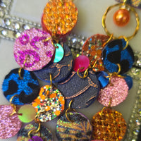 Ivonne orange multicolored round dangle earrings with geometric patterns, crafted by Shop Moxxc.