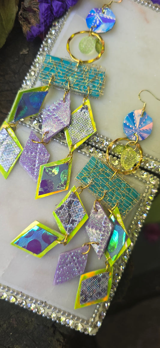 Pastel multicolored fringe earrings by Joyce with layered fabric strands hanging from gold hooks, stylish and vibrant accessory.