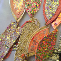 Yellow long statement earrings featuring angelica design from Shop Moxxc, showcasing their vibrant color and intricate detailing.