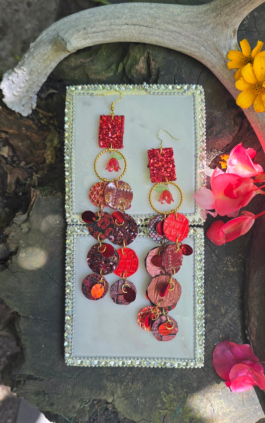 Red long round dangle earrings from Karina collection by Shop Moxxc, featuring elegant, circular design with dangling elements.