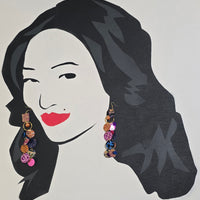 Multicolored round dangle earrings in orange by Ivonne, featuring vibrant, circular design with gold hooks.
