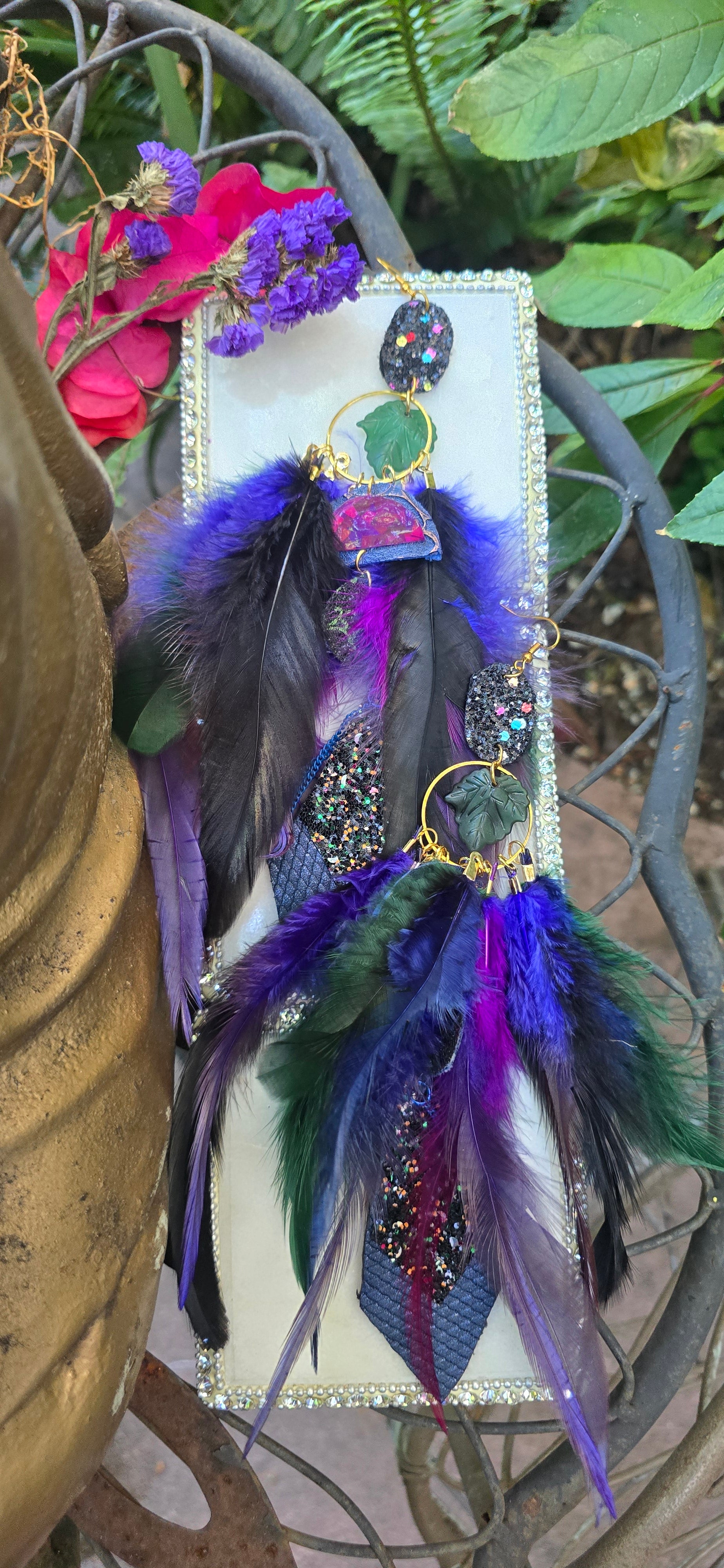 Dark blue feather earrings named Helen, featuring lightweight feather design with silver hooks, from Shop Moxxc.