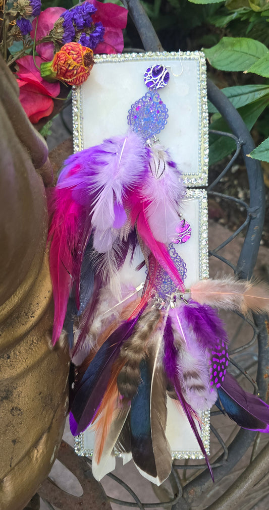 Purple feather earrings featuring bohemian style with vibrant feathers, designed by Shop Moxxc, perfect for festival accessories.