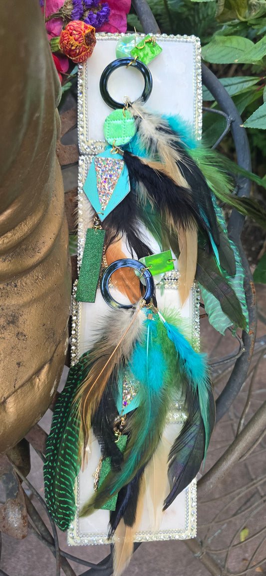 Green feather festival earrings with intricate design, featuring vibrant feathers and silver accents, perfect for boho or festival styles.
