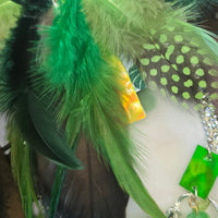 Green feather boho earrings by Shop Moxxc featuring layered feather design and intricate bead accents.