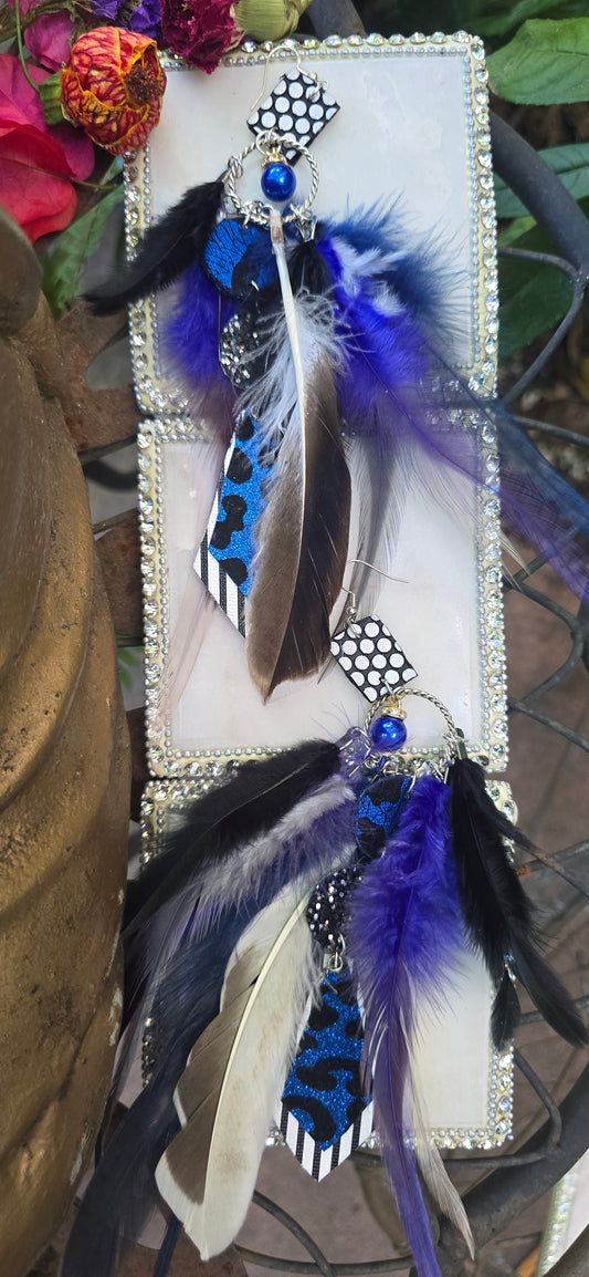 Blue animal print feather earrings featuring long feathers, styled with intricate details, from Shop Moxxc.