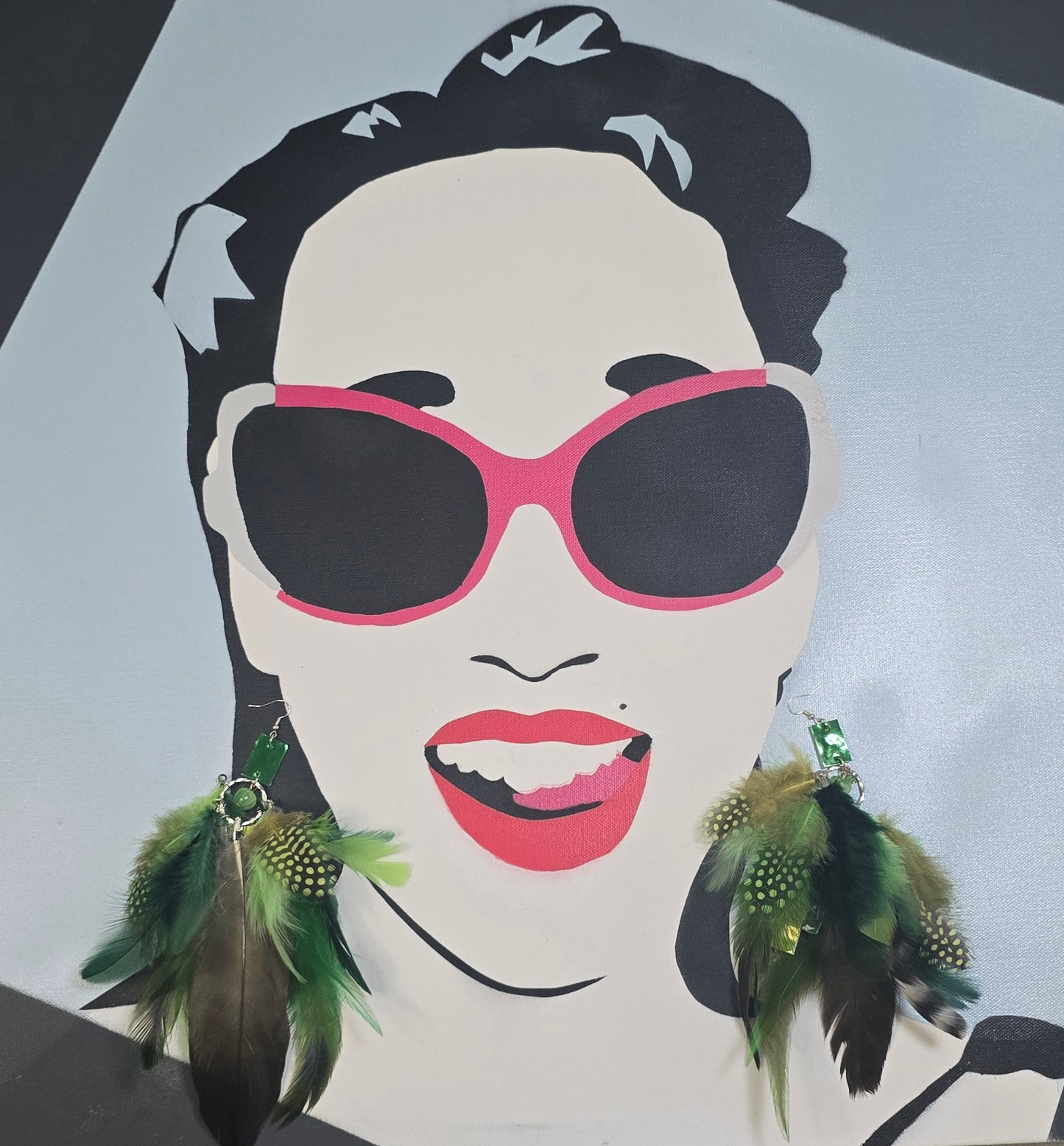 Green feather boho earrings with gold accents, featuring layered feather design and dangle style from Shop Moxxc.