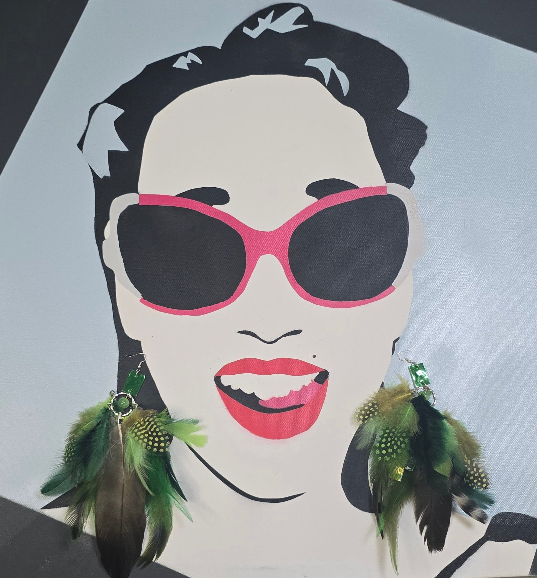Green feather boho earrings with gold accents, featuring layered feather design and dangle style from Shop Moxxc.