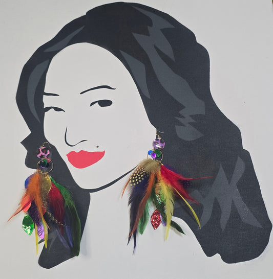 Colorful rainbow feather earrings featuring delicate feathers, showcased on a model wearing the Shop Moxxc Cassie earrings.