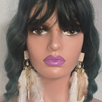 Leah white long feather earrings by Shop Moxxc hanging from ears, featuring delicate feather details and elegant design.