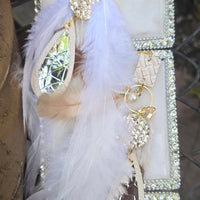 White long feather earrings by Shop Moxxc featuring elegant feather design and lightweight dangle style.